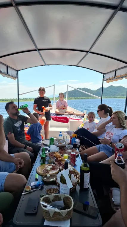 Guests sharing homemade food on the covered boat