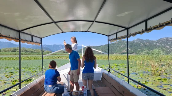Guests on the covered boat looking out over the lily fields