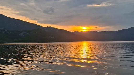 Sunset over Skadar Lake with the mountains silhouetted against the sky
